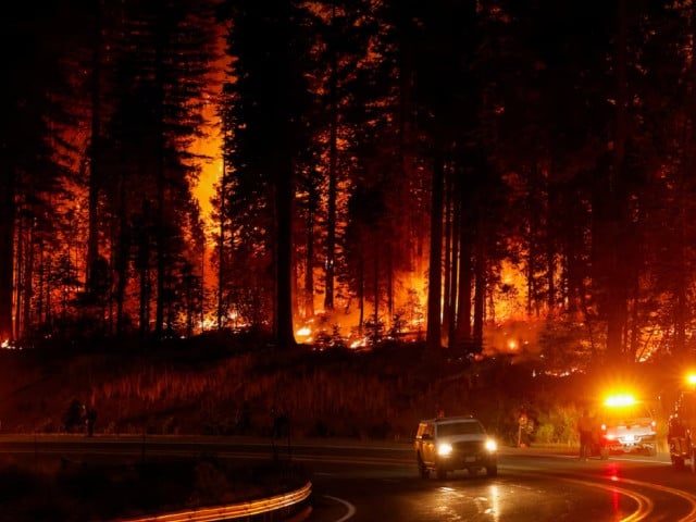 a vehicle passes firefighters standing by the road as the park fire burns near jonesville california u s july 28 2024 photo reuter